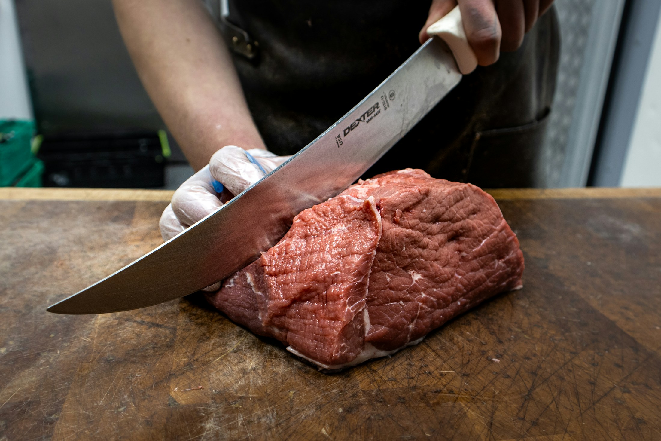 Illustrative stock image: raw meat being cut; not a photograph of Hansa production